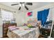 Comfortable bedroom with ceiling fan, natural light, and space for a dresser at 1850 S Williams St, Denver, CO 80210