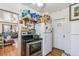 Modest kitchen with stainless steel appliances and ample shelving for storage at 1850 S Williams St, Denver, CO 80210