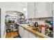 Practical kitchen featuring white cabinets, wood countertops, and open shelving at 1850 S Williams St, Denver, CO 80210