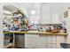 Functional kitchen with white cabinets, wood countertops, and a stainless steel dishwasher at 1850 S Williams St, Denver, CO 80210