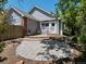 The home features a stone patio, walkway, a small fenced-in yard, and a chair for outdoor seating at 6900 W Grant Ranch Blvd # 49, Littleton, CO 80123