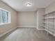 A finished basement featuring neutral colors, carpet, a window, and built-in shelving for ample storage at 6900 W Grant Ranch Blvd # 49, Littleton, CO 80123