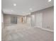 Spacious finished basement with neutral carpet, recessed lighting, and multiple doorways at 6900 W Grant Ranch Blvd # 49, Littleton, CO 80123