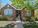Charming brick home featuring a well-maintained front yard and inviting entrance at 6900 W Grant Ranch Blvd # 49, Littleton, CO 80123