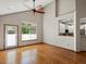 Bright and open living room with hardwood floors, a vaulted ceiling, and a modern ceiling fan at 6900 W Grant Ranch Blvd # 49, Littleton, CO 80123