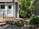 A walkway and patio lead to a side entrance to the home, with garden area to the side at 6900 W Grant Ranch Blvd # 49, Littleton, CO 80123