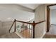 Elegant staircase with white railings and wood accents overlooking the living room at 6900 W Grant Ranch Blvd # 49, Littleton, CO 80123