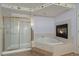 Inviting bathroom boasts a separate shower, a corner fireplace, and a luxurious soaking tub at 10155 Charissglen Ln, Littleton, CO 80126