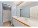 Bathroom featuring a double sink vanity, tile flooring, and tub with shower at 10155 Charissglen Ln, Littleton, CO 80126