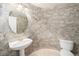 Stylish half bathroom with unique wall treatment and pedestal sink at 10155 Charissglen Ln, Littleton, CO 80126