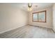 Bedroom features wood-look tile floors, ceiling fan, and window with wood blinds at 10155 Charissglen Ln, Littleton, CO 80126