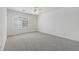 Bright bedroom with a large window, neutral carpet, and white trim at 10155 Charissglen Ln, Littleton, CO 80126