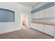 Spacious bonus room with plenty of storage, counter space, and neutral colored walls at 10155 Charissglen Ln, Littleton, CO 80126