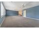 Expansive bonus room featuring plush carpeting, ample natural light, and neutral wall paint at 10155 Charissglen Ln, Littleton, CO 80126