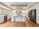 Spacious kitchen featuring a large center island and stainless steel appliances at 10155 Charissglen Ln, Littleton, CO 80126