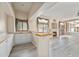 Open living space features a fireplace, wet bar, and wood-look floors at 10155 Charissglen Ln, Littleton, CO 80126