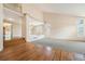Sunlit living room featuring hardwood floors, vaulted ceilings, and an open layout for entertaining at 10155 Charissglen Ln, Littleton, CO 80126