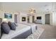 Bright main bedroom with fireplace, plush carpeting, white walls, and a ceiling fan for added comfort at 10155 Charissglen Ln, Littleton, CO 80126