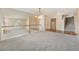 Open-concept space featuring neutral carpeting and a view of stairs and living room below at 10155 Charissglen Ln, Littleton, CO 80126