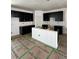 Spacious kitchen features dark cabinets, ample counter space, and a center island perfect for cooking at 22 Waterford St, Erie, CO 80516