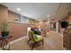 Finished basement with exposed brick wall, recessed lighting, and neutral carpeting and paint at 1840 S Grant St, Denver, CO 80210