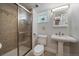 Bathroom featuring a glass enclosed shower, bright window, and pedestal sink at 1840 S Grant St, Denver, CO 80210