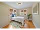 Comfortable bedroom featuring a single bed, hardwood floors, and natural light from three windows at 1840 S Grant St, Denver, CO 80210
