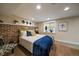 Cozy bedroom with exposed brick, bright natural light, and tasteful modern decor at 1840 S Grant St, Denver, CO 80210