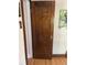 A stunning, stained, solid wood paneled door with vintage glass knob and brass hardware at 1840 S Grant St, Denver, CO 80210