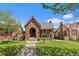 Inviting brick home with a quaint, covered porch, creating a welcoming entrance and classic curb appeal at 1840 S Grant St, Denver, CO 80210