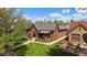 Charming brick home with a well-manicured lawn and inviting front porch, perfect for relaxing on summer evenings at 1840 S Grant St, Denver, CO 80210