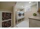 Convenient laundry room with modern washer and dryer units, and tasteful decor at 1840 S Grant St, Denver, CO 80210