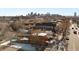 Aerial view of a house and surrounding neighborhood with city skyline in background at 3558 Pecos St, Denver, CO 80211