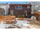 Small backyard with patio, wooden table and chairs, and snow at 3558 Pecos St, Denver, CO 80211