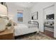 Bright bedroom featuring a metal bed frame, neutral decor, and view of living room at 3558 Pecos St, Denver, CO 80211