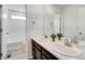 Bathroom featuring double sinks, marble countertops, and sleek finishes at 12777 Clearview St, Firestone, CO 80504