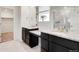Bathroom featuring dual sinks, granite countertops, and a glass shower at 12777 Clearview St, Firestone, CO 80504