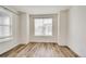 Bedroom featuring new hard wood floors and a large window at 12777 Clearview St, Firestone, CO 80504