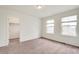 Bright, neutral bedroom with tan carpet and a walk-in closet at 12777 Clearview St, Firestone, CO 80504
