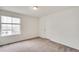 Minimalist bedroom with neutral carpet and walls and a light fixture at 12777 Clearview St, Firestone, CO 80504