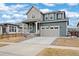 Attractive two-story home featuring a two-car garage, a front porch, and blue siding at 12777 Clearview St, Firestone, CO 80504