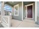Charming front porch with gray siding, white trim, and a covered entryway into the home at 12777 Clearview St, Firestone, CO 80504