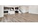 Open-concept home featuring a kitchen with a large island, stainless appliances, and seamless flow to the living area and staircase at 12777 Clearview St, Firestone, CO 80504
