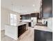 Well-equipped kitchen with a granite island, stainless steel appliances, and sleek dark cabinetry at 12777 Clearview St, Firestone, CO 80504