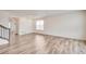 Bright living room featuring wood flooring and large windows allowing ample natural light at 12777 Clearview St, Firestone, CO 80504