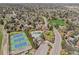 Aerial view featuring community tennis courts and a pool surrounded by homes and mature trees at 7888 S Magnolia Way, Centennial, CO 80112