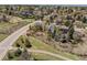 Aerial view of a quiet neighborhood with tree-lined streets, green spaces, and nearby amenities at 7888 S Magnolia Way, Centennial, CO 80112