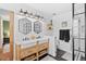 Bright bathroom features a double sink, modern lighting, and a beautiful glass enclosed shower at 7888 S Magnolia Way, Centennial, CO 80112