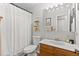 Bathroom featuring white shower curtain, toilet, wood cabinet with sink, and modern fixtures at 7888 S Magnolia Way, Centennial, CO 80112