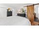Bright bedroom featuring modern decor, black dressers, and a stylish sliding barn door at 7888 S Magnolia Way, Centennial, CO 80112